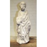Large stone sculpture of a saintly figure. Considerable age-related wear, with damage to head (