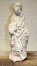 Large stone sculpture of a saintly figure. Considerable age-related wear, with damage to head (