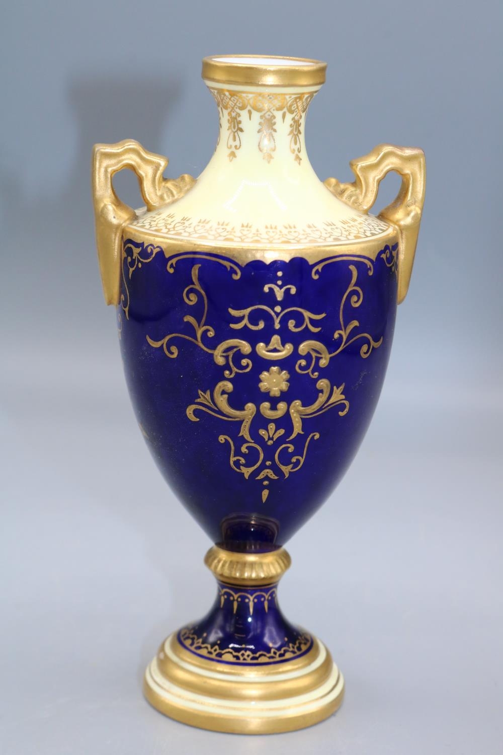 Coalport porcelain two handled urn, decorated with a lake scene vignette, within blue and gilt - Image 2 of 3