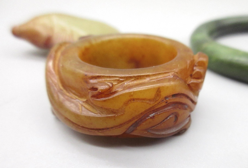 Chinese jade archers thumb ring carved with two dragons, a carved jade fish pendant and a polished - Image 2 of 3