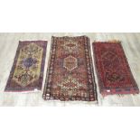 Persian red ground saddle bag and two small Caucasian rugs, 120cm x 70cm max (3) (Victor B