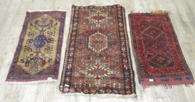 Persian red ground saddle bag and two small Caucasian rugs, 120cm x 70cm max (3) (Victor B