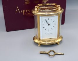 Asprey & Garrard London, 8 day oval brass carriage clock timepiece, signed white enamel Roman