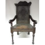 Oak Wainscot type arm chair, lozenge panel back and solid seat on turned supports with ball feet,