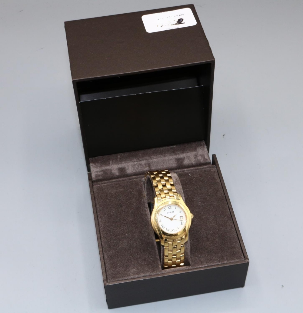 Ladies Gucci gold plated quartz wristwatch with date on matching bracelet, signed butterfly clasp, - Image 2 of 2