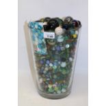 Anne Nilsson design glass vase containing a large quantity of marbles, H28cm