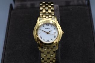 Ladies Gucci gold plated quartz wristwatch with date on matching bracelet, signed butterfly clasp,