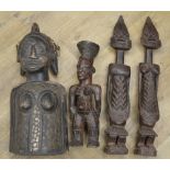 A selection of four carved wooden figures originating from across the african continent. To