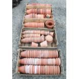 Large quantity of early 20th century and later terracotta plant pots of various sizes, in four