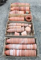 Large quantity of early 20th century and later terracotta plant pots of various sizes, in four