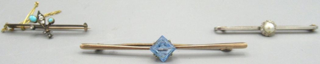 Yellow metal brooch set with turquoise and diamond, another similar brooch set with blue stone,