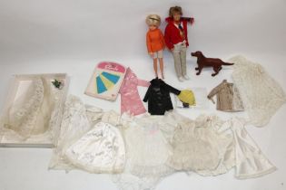 Early 1980s Sindy doll in orange top, later Paul doll, Sindy and Patch clothes and hat, and a