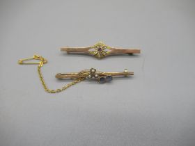 Yellow metal bar brooch set with amethyst and seed pearl floral cluster, and another yellow metal