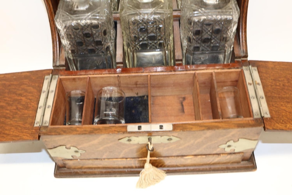 Late 19th century oak three bottle tantalus, metal mounts, twin lidded compartment, with key and - Image 2 of 2