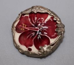 Moorcroft Pottery: ‘Hibiscus’ pattern ceramic roundel set in a silver foliate mount, mount stamped