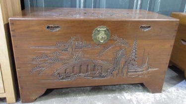 Chinese camphor lined blanket box carved with landscapes, brass lock on bracket feet, W101cm D50cm