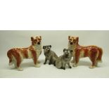 Pair of Bo'ness pottery style models of standing dogs decorated in red and white, and a pair of