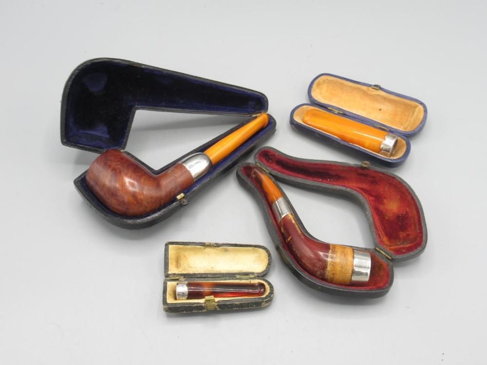 Two pipes and two cheroot holders, all with silver mounts, all cased (5)
