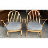 Pair of Ercol hoop and stick back arm chairs, with loose seat cushions on turned outsplayed