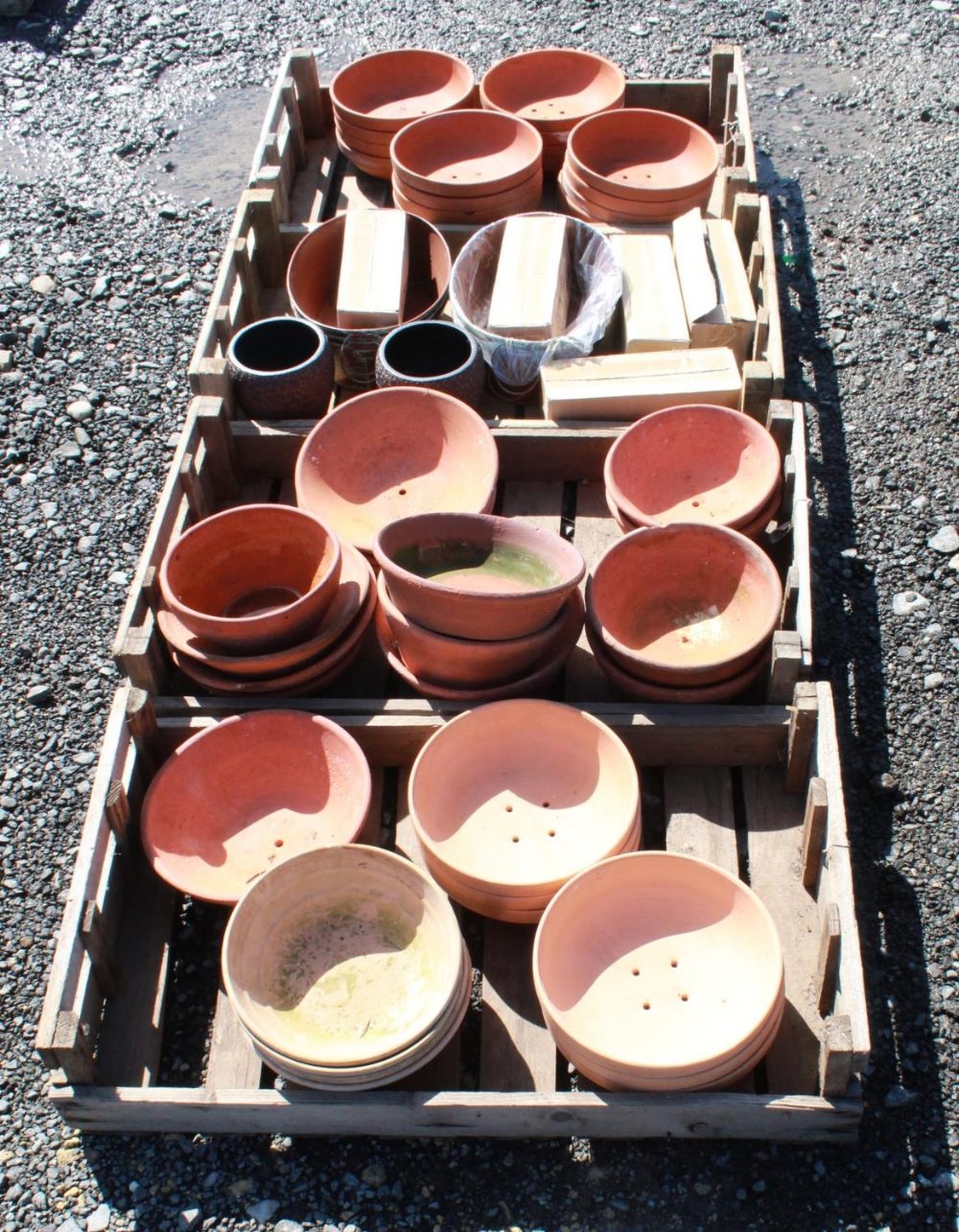 (Large quantity). Four crates of terracotta plant pot holders of various sizes and ages