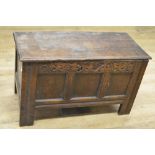 18th century oak coffer with spilt pin hinged top, three panel front with strapwork carved frieze