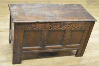 18th century oak coffer with spilt pin hinged top, three panel front with strapwork carved frieze