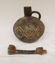 A small embossed ceramic jug in the Indo-Peruvian style. Accompanied by a ceramic flute in