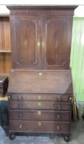 C18th oak bureau bookcase, the top with two inlaid panel doors, fitted interior with concealed