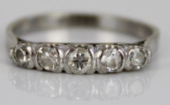 White metal five stone diamond ring, the round cut diamonds in rub-over settings, on plain shank, no