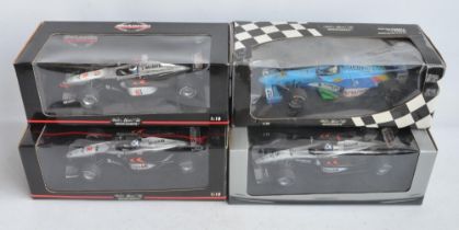 Four 1/18 scale diecast Formula 1 racing car models from Paul's Model Art/Minichamps to include