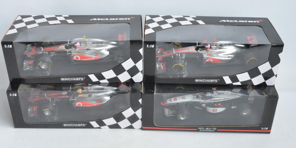 Four boxed 1/18 scale Formula 1 racing car models from Paul's Model Art/Minichamps, all McLaren