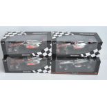 Four boxed 1/18 scale Formula 1 racing car models from Paul's Model Art/Minichamps, all McLaren