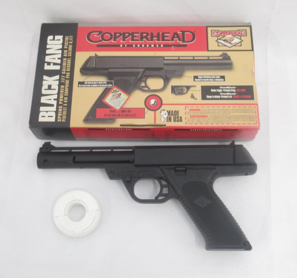 Copperhead Black Fang spring powered .177 caliber air pistol, with metal BB pellets in white donut