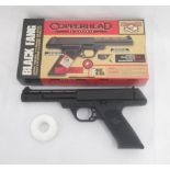 Copperhead Black Fang spring powered .177 caliber air pistol, with metal BB pellets in white donut