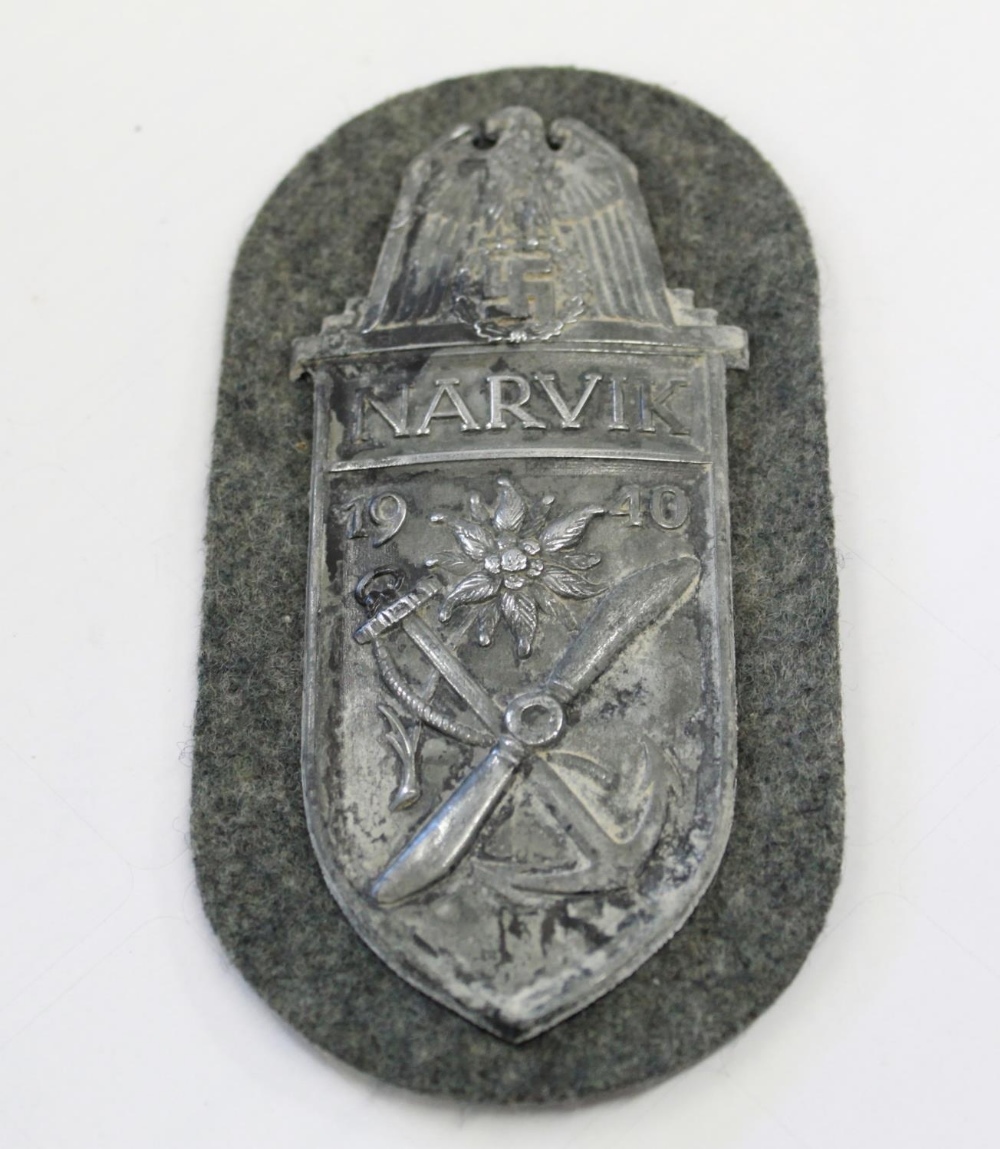 WWII German Narvik Shield with cloth backing. backing paper and four prongs intact