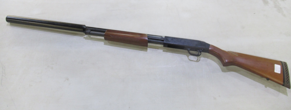 Mossberg pump-action 410 shotgun with fitted moderator. Serial number V0719512. Barrel and moderator