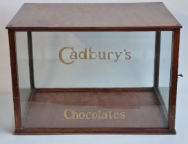 Shop style wood and glass display cabinet with hand-painted "Cadbury's Chocolates" to front, W59.