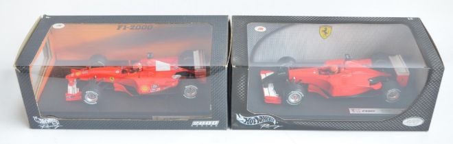 Two 1/18 scale diecast Michael Schumacher Collection F1 Ferrari models from Hot Wheels Racing with