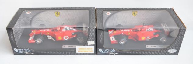 Two 1/18 scale diecast Michael Schumacher Collection F1 Ferrari F2001 models from Hot Wheels