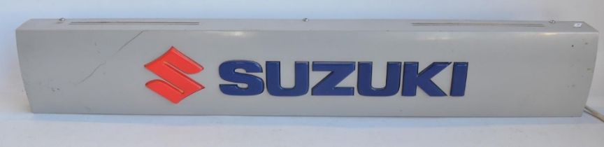 Illuminated Suzuki dealership advertising board, metal case with plastic relief lettering in full