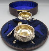 George III silver pair of salts with three shell cast hoof feet, fluted rim, repousse floral