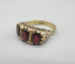 9ct yellow gold ring set with three red stones in ornate mount, stamped 9ct, size N1/2, 3.5g