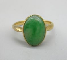 Yellow metal jade ring, the oval cut cabochon jade in rub over mount, unmarked, size N, 3.77g