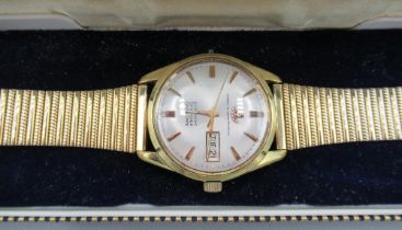 Watches of Switzerland Seafarer gold plated wristwatch with day date, signed silvered sunburst dial,