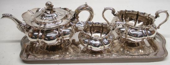 George 1V three piece silver tea service, melon shaped bodies with fluted S scroll handles on