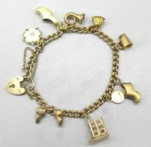 9ct yellow gold charm bracelet with heart padlock closure, set with nine 9ct yellow gold charms