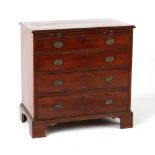 Property of a lady - a small George III mahogany chest of four long graduated drawers with