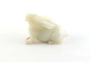 A Chinese carved white jade model of a Rabbit, probably 20th century, 3ins. (7.6cms.) long, 2.