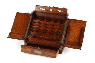 Property of a lady - a late 19th / early 20th century oak stationery box with sloping front, one