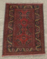Property of a gentleman - an Afghan hand-knotted wool rug, 57 by 41ins. (145 by 104cms.).